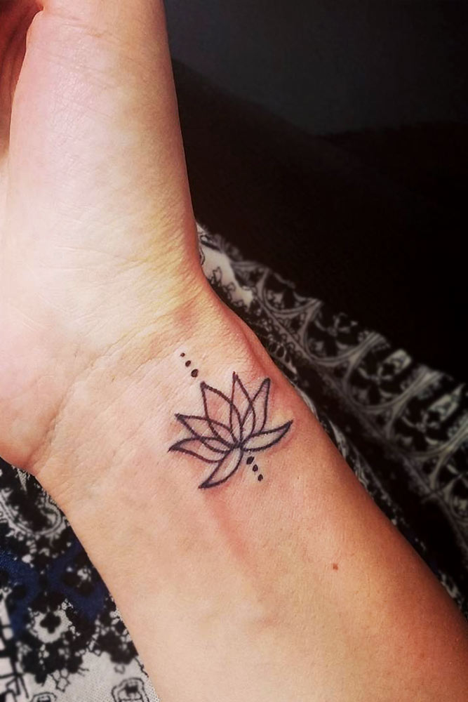 small lotus flower tattoo on foot