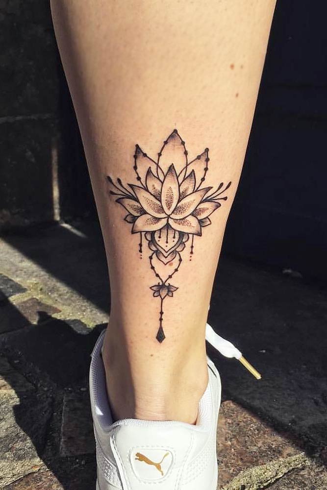 Minimalist lotus flower tattoo on the ankle