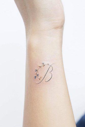 Side Wrist Tattoo With Letter #flowerstattoo #lettertattoo