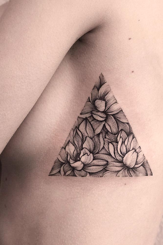 Femininity Empowers #sidetattoo #triangletattoo #flowerstattoo