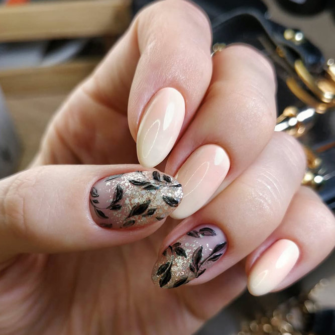 Fancy Nails With Black Floral Design #beigenails #nudenails #ovalnails #glitternails #floralnails