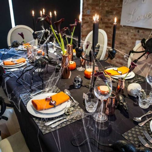 Vintage Halloween Table Setting With Webs And Flowers