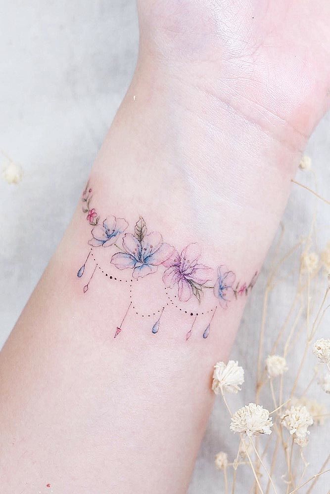 Tiny Watercolor Flowers On Wrist #wristtattoo #flowertattoo