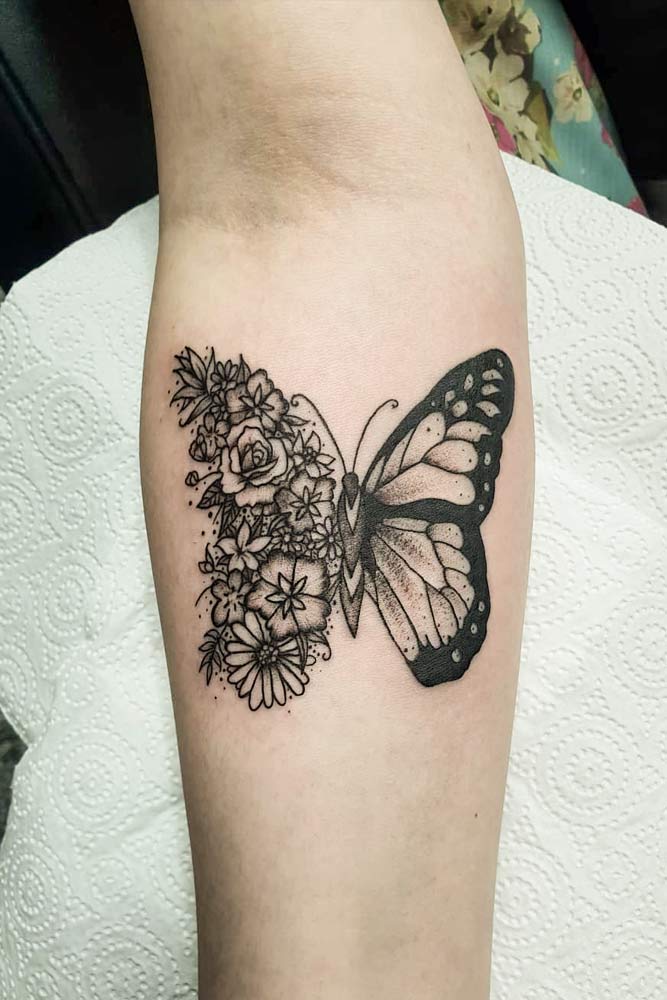 Half butterfly half flower tattoo on the bicep