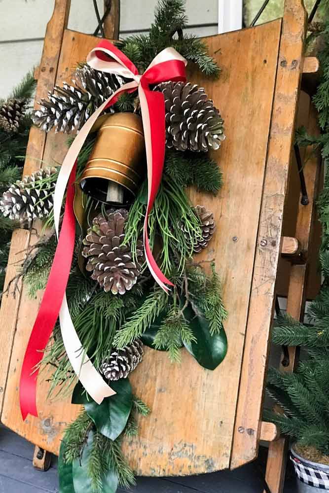 Rustic Sledge With Bells And Greenery #sledge #bells #cones