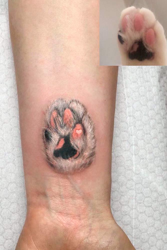 cat paw print tattoo on wrist