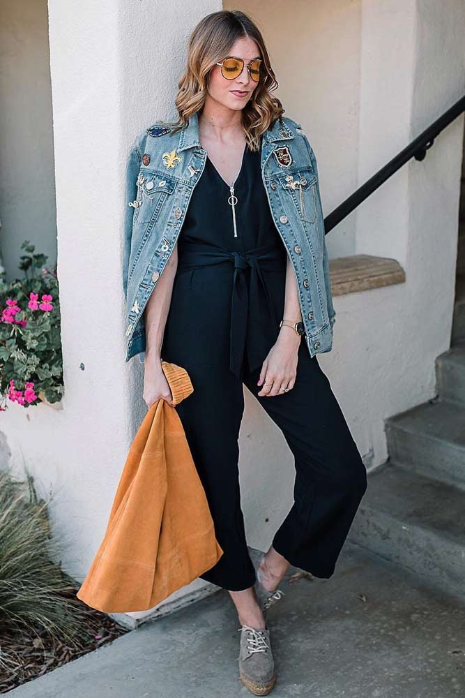 black jumpsuit and denim jacket