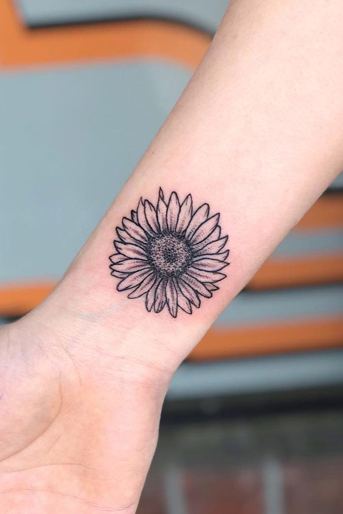 Micro-realistic sunflower bracelet tattoo on the wrist.