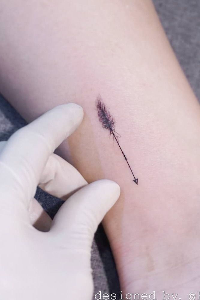 Wrist tattoo of an arrow.