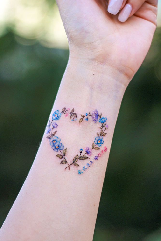 Flower Wreath With Heart Shape Tattoo #wristtattoo #floraltattoo