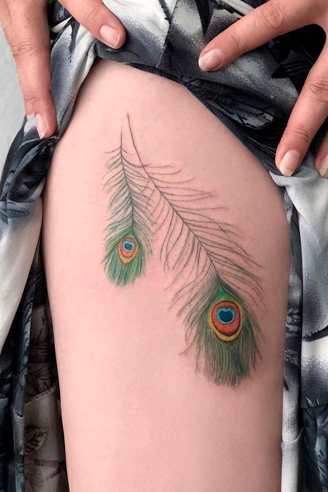 peacock feather tattoo on thigh