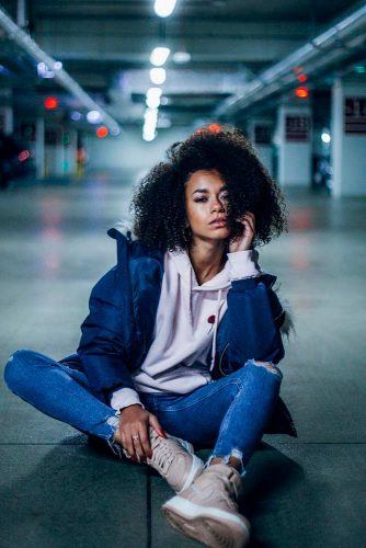 A beautiful attractive model poses with her back to the camera. Concept  photo for clothing brands Stock Photo by shotprime