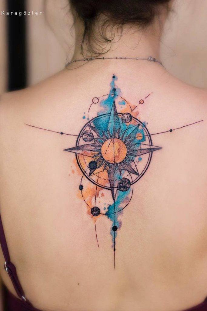 Sun and moon tattoo on the upper back.