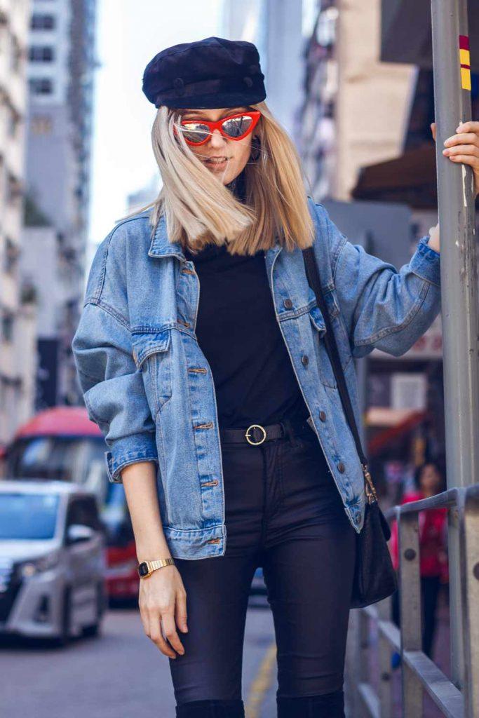 denim jacket black leather pants gatsby cap sunglasses