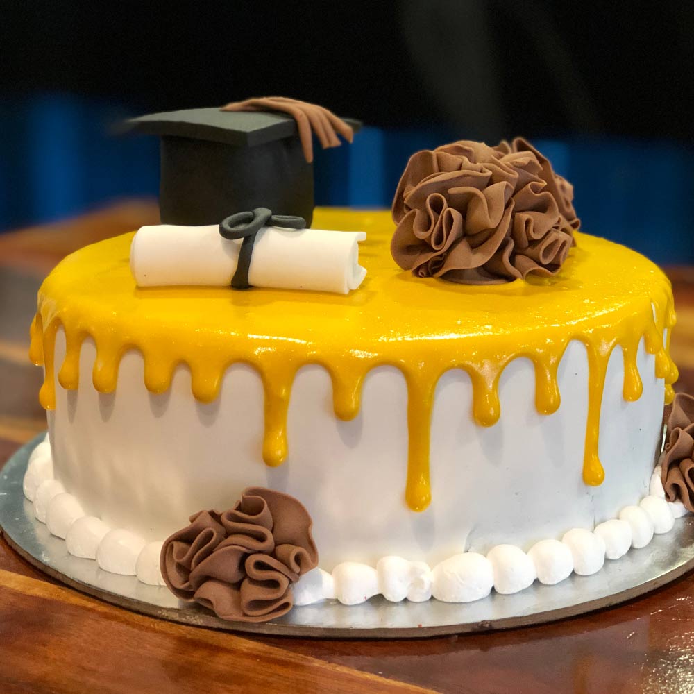 Graduation Cake with a Cap and Yellow Base