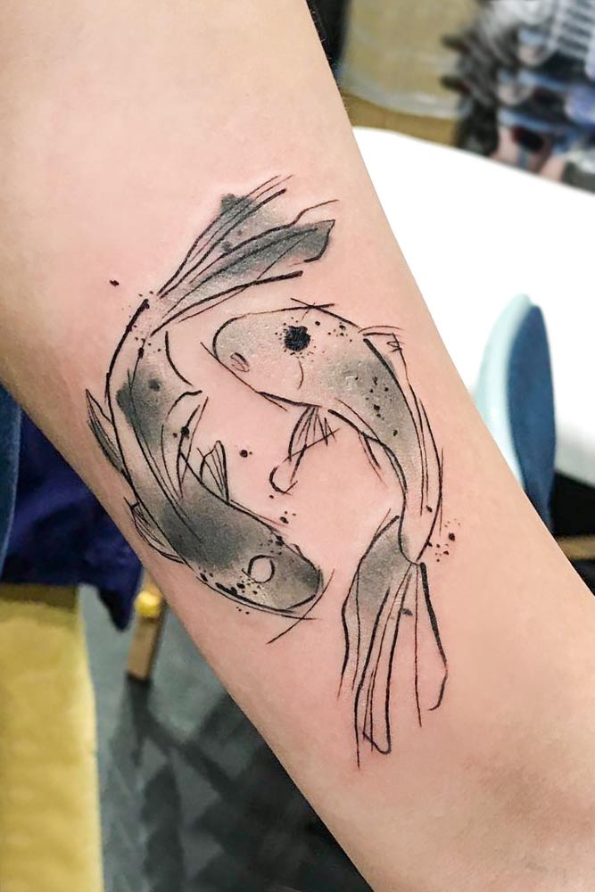 Watercolor style koi fish tattoo on the forearm