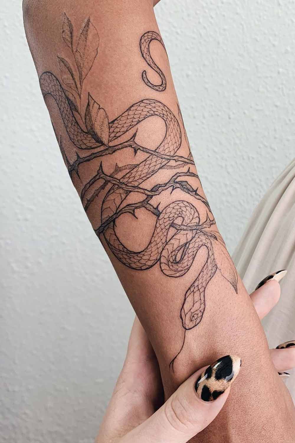 Snake tattoo on the inner forearm.