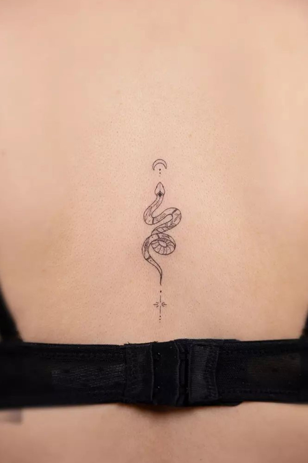 Fine line snake tattoo located on the hip