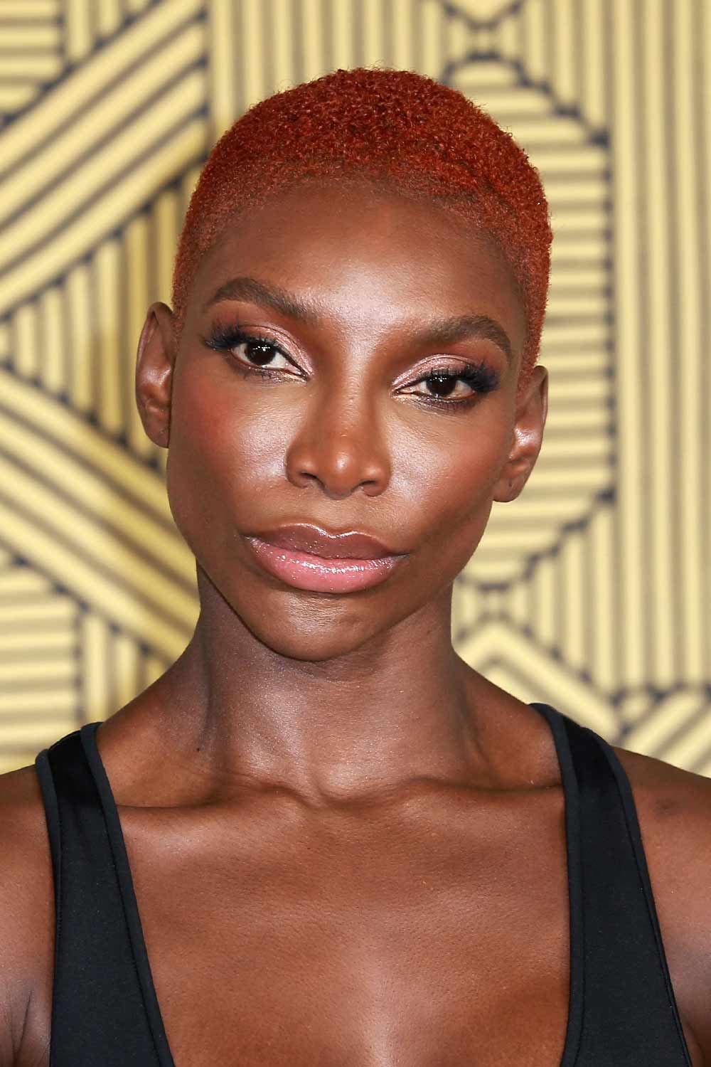 Michaela Coel with a Red Buzz Cut