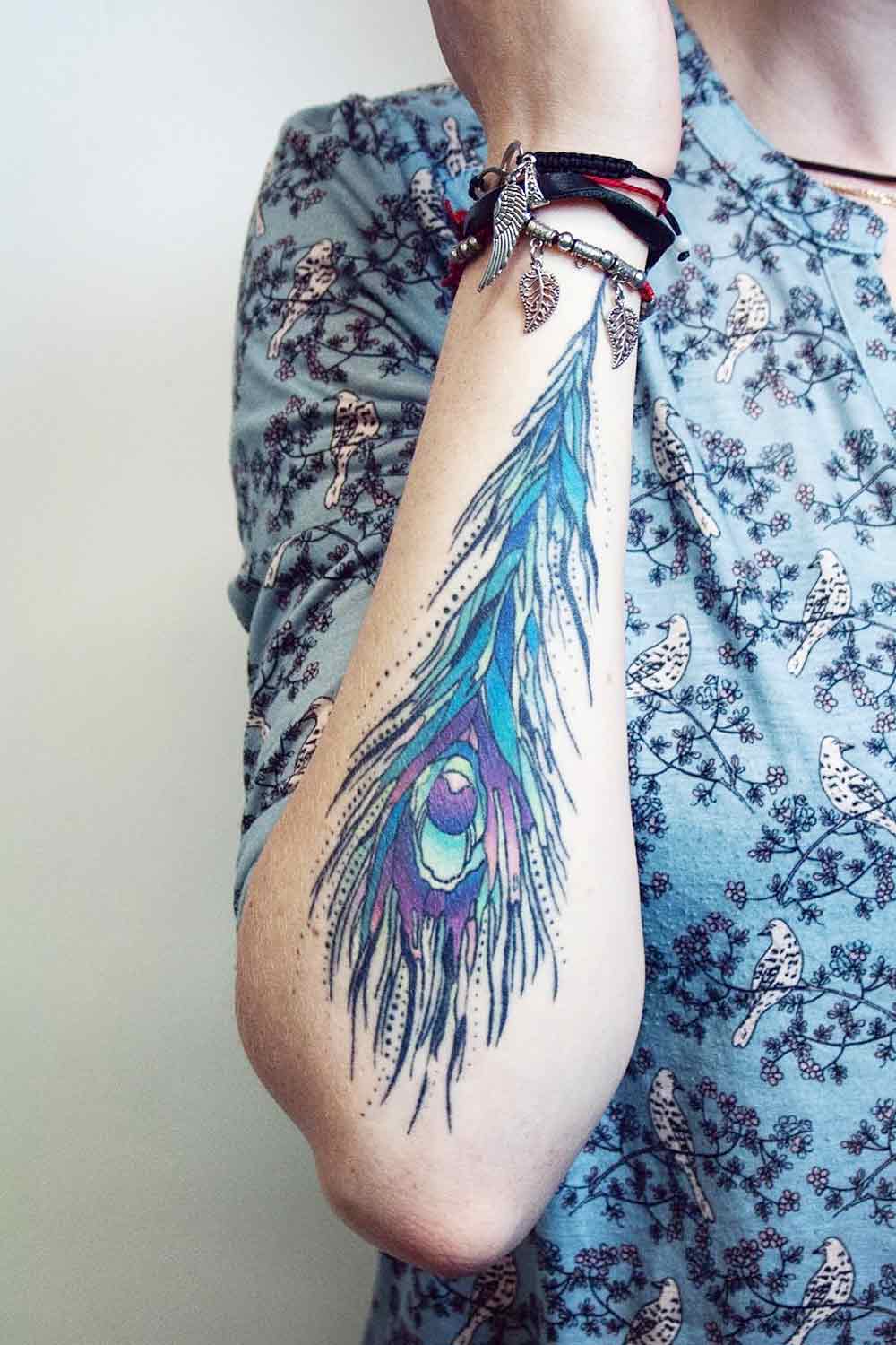 peacock feather tattoos on arm