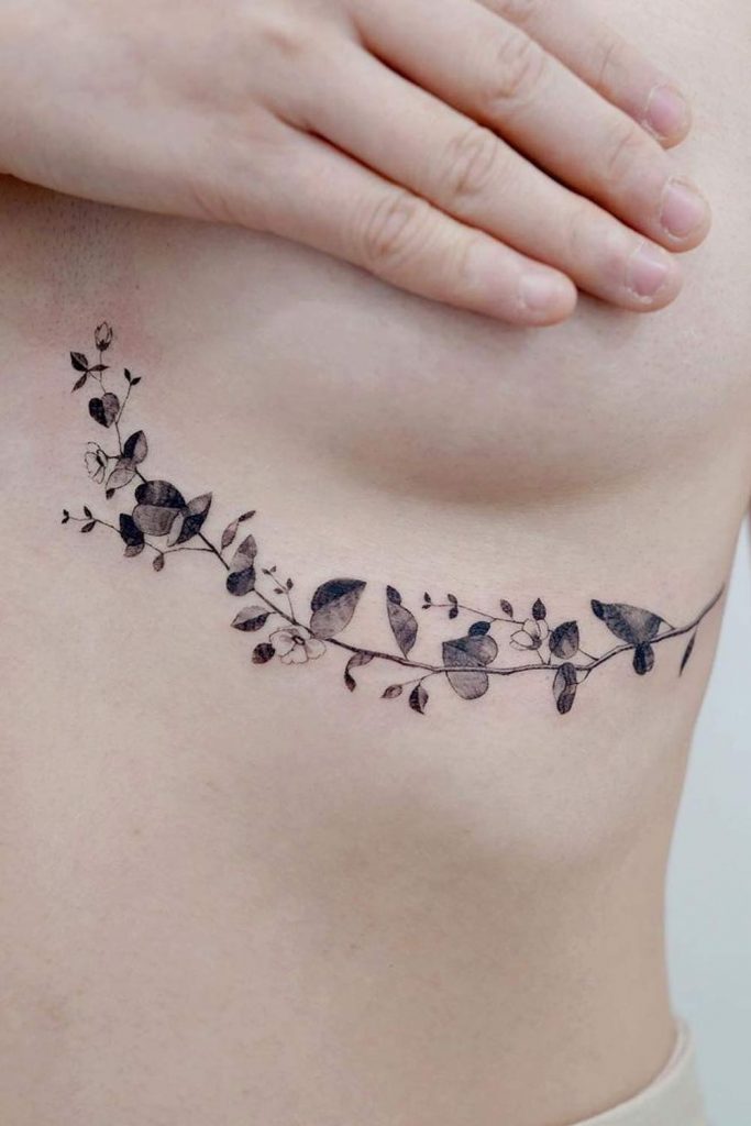 Fine line vine tattoo on the sternum