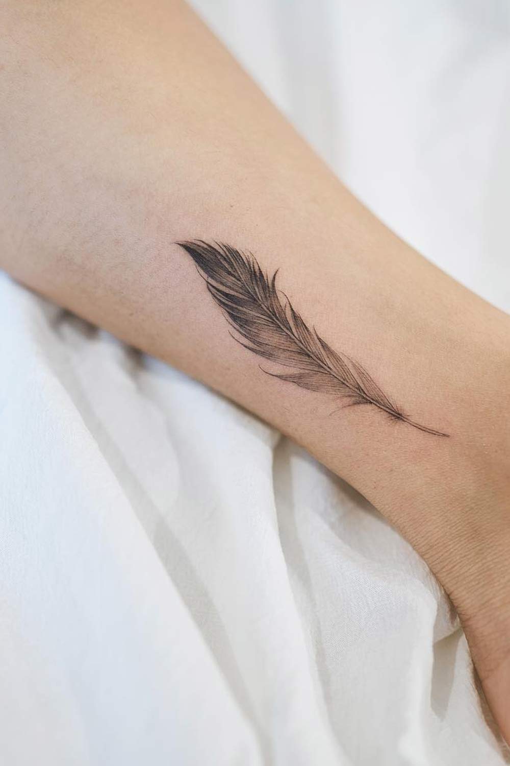 feather tattoos on wrist