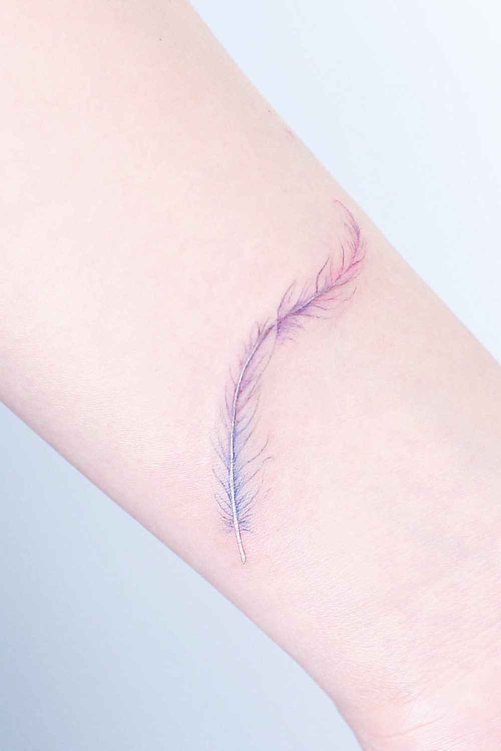 Minimalist and Tender Feather Tattoo