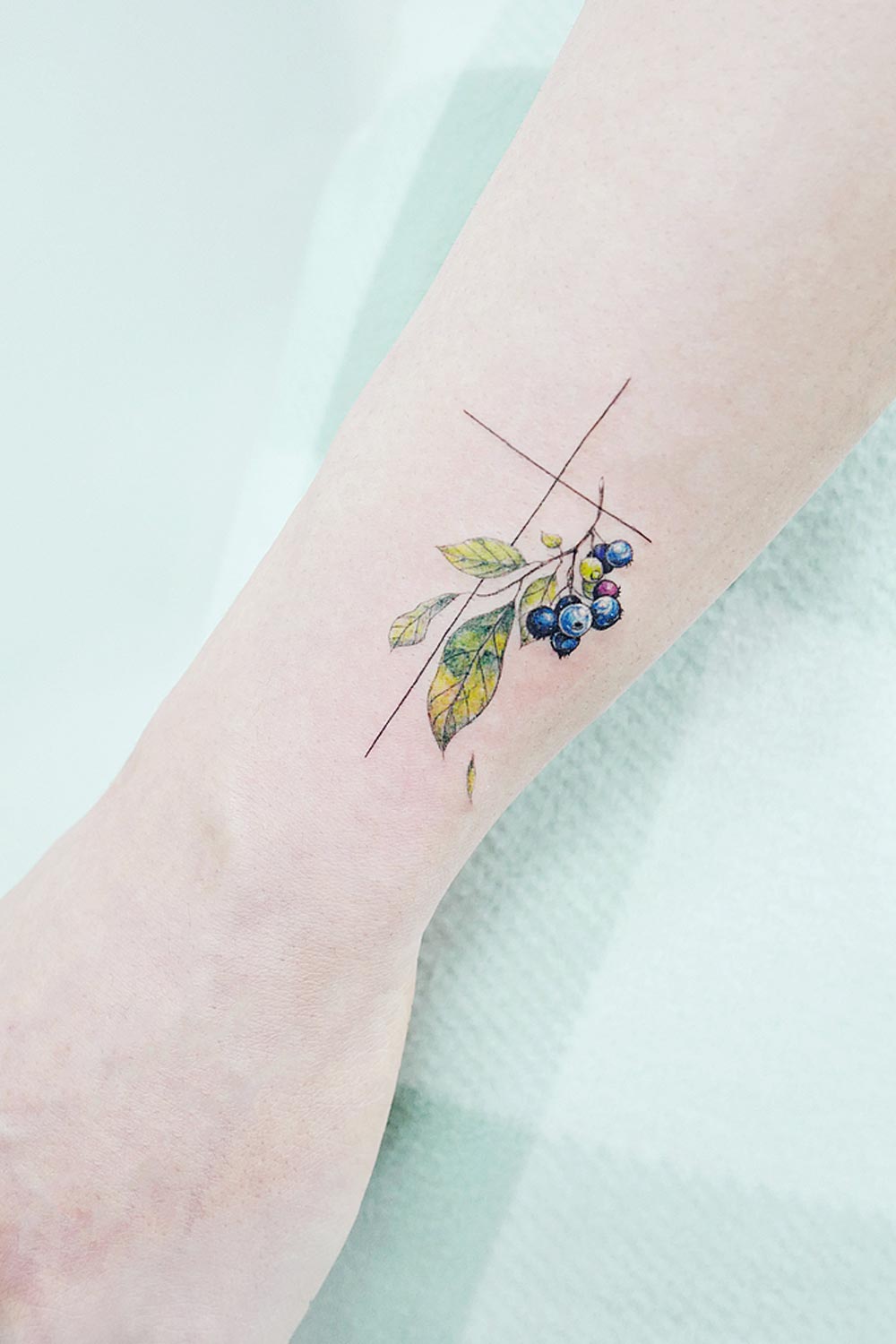 Small Cross with Blueberry Tattoo Design