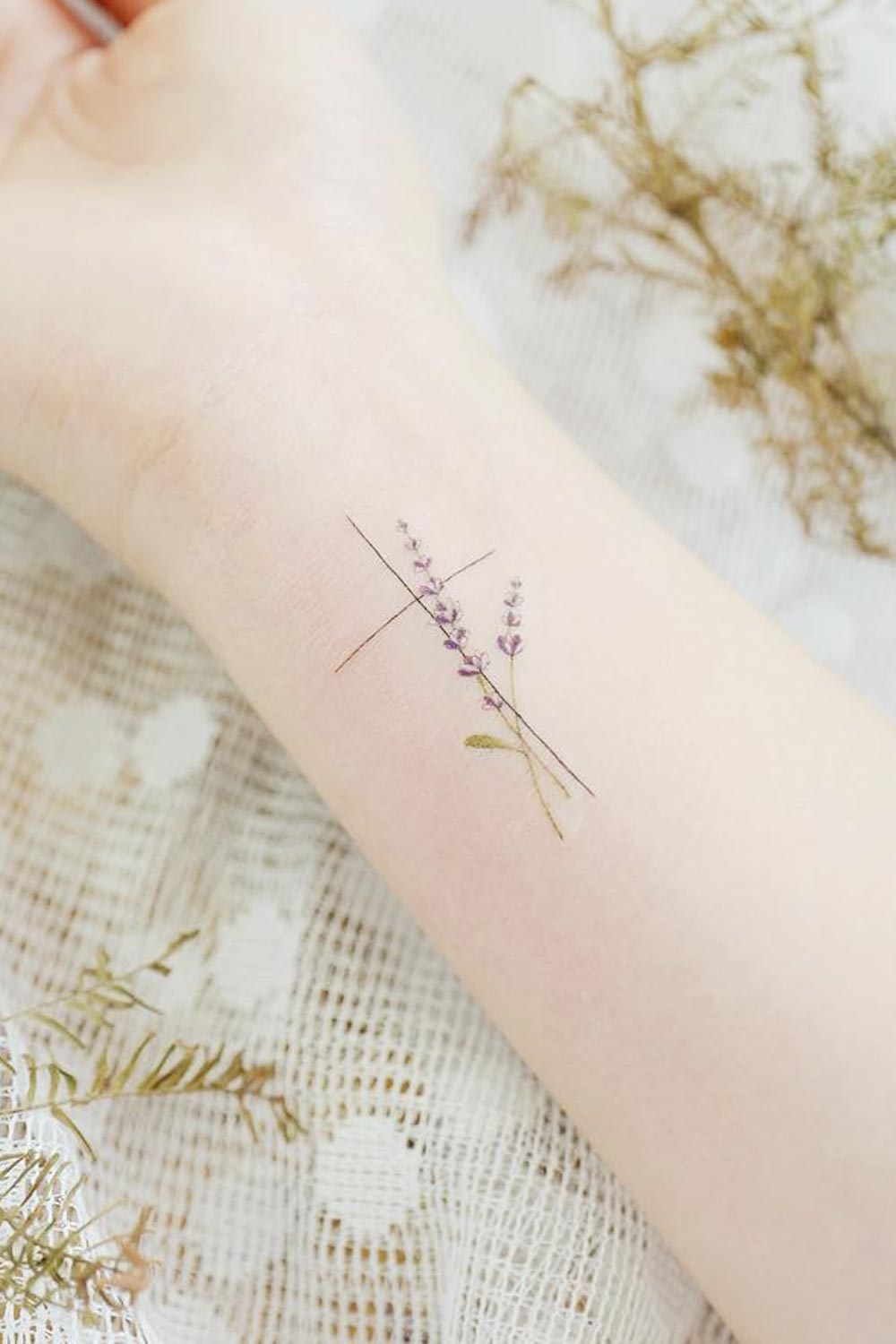 Minimalist Wrist Tattoo with Cross and Flowers