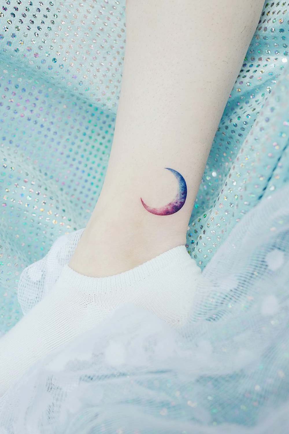 Minimalist star, saturn and moon tattoo on the ankle.