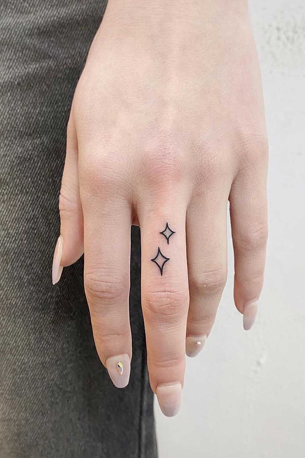 Hand poked north star tattoo on the finger