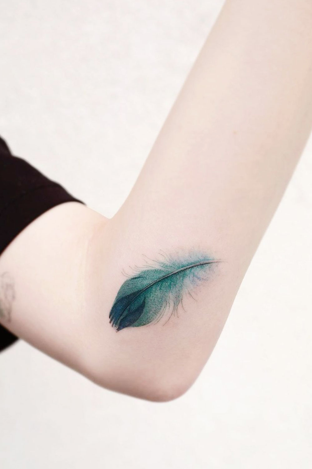 Green Watercolor Feather Arm Tattoo