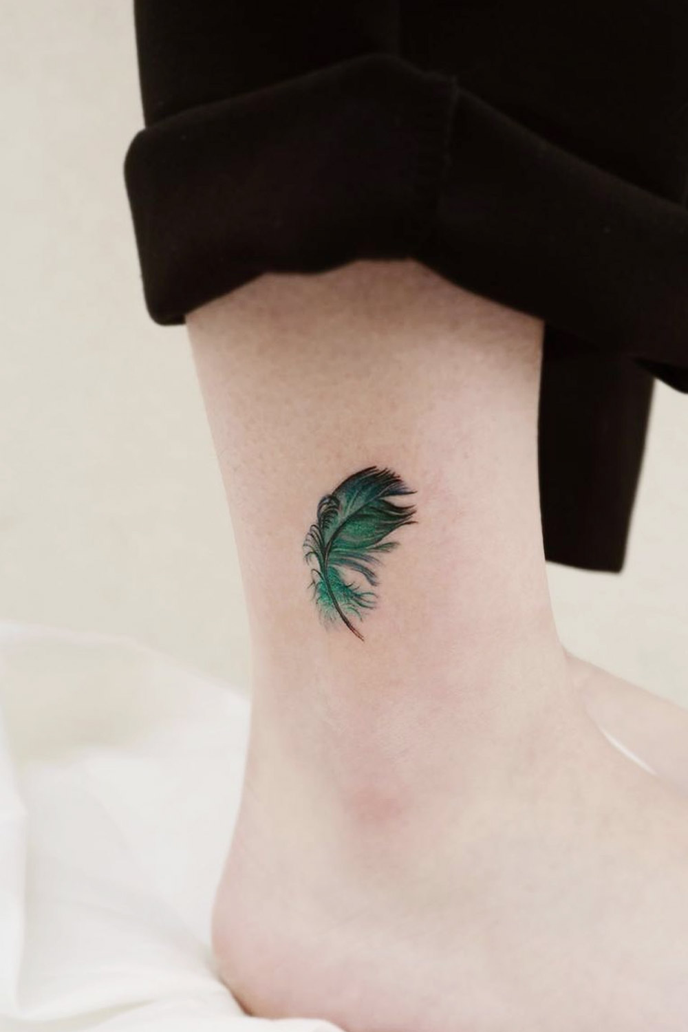 Emerald Colored Feather Ankle Tattoo