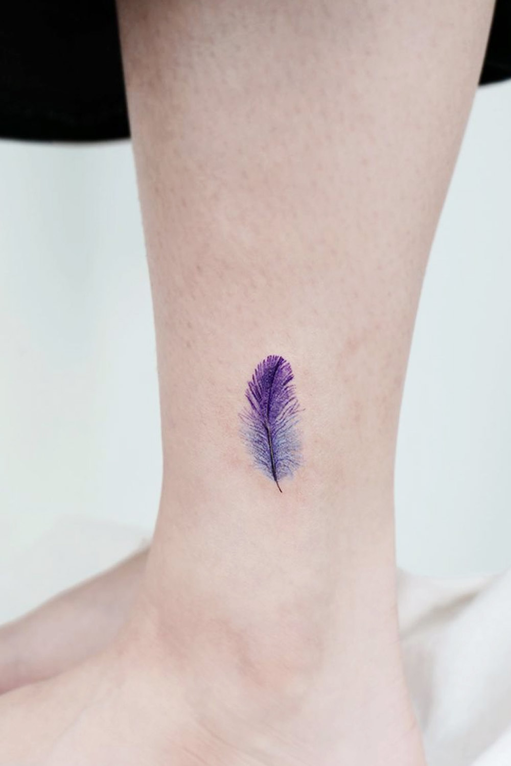 Small feather tattoo on the ankle.