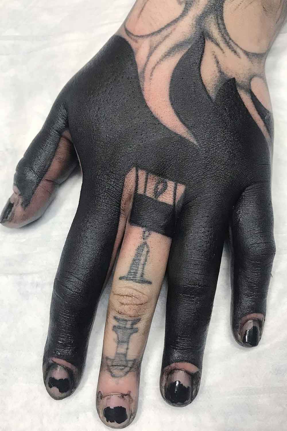 Hand Blackout Tattoo