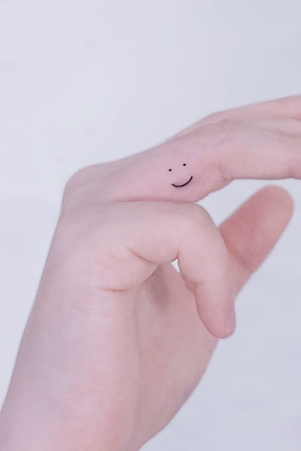 Smile Tattoo Minimalist Finger Placement