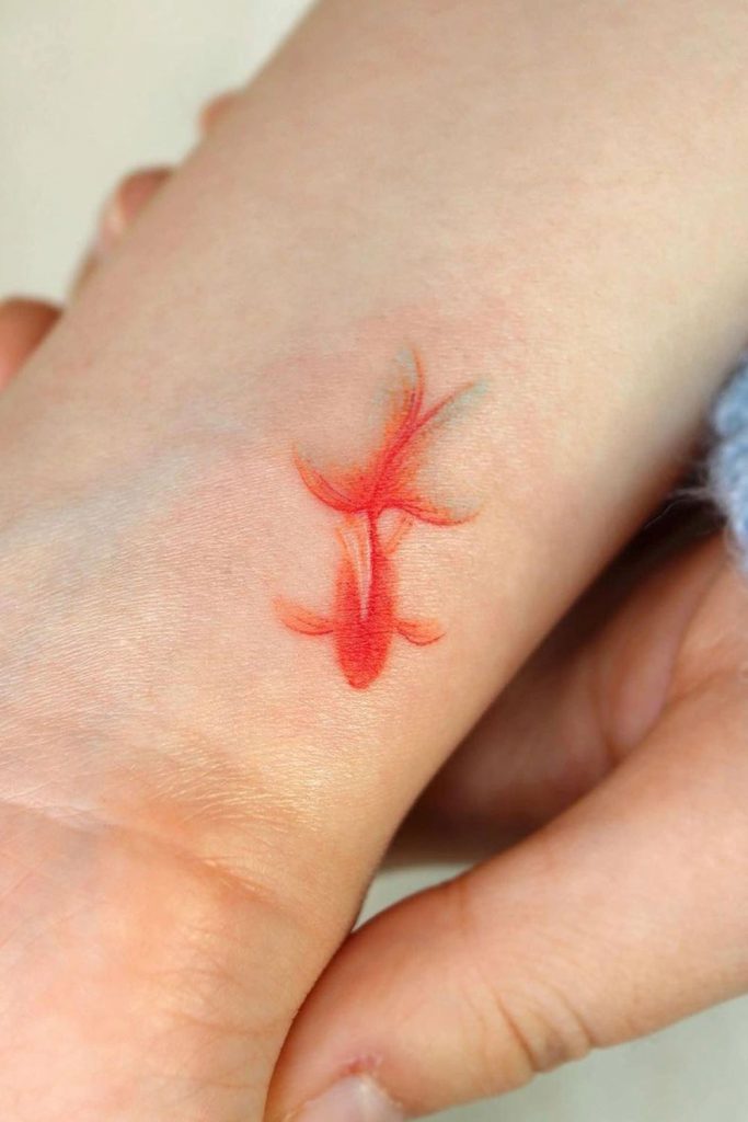 Dotwork fish tattoo located on the finger, minimalistic