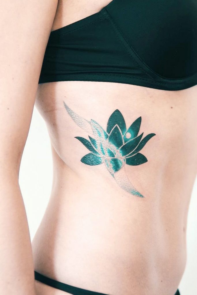 Teal Lotus Rib Tattoo