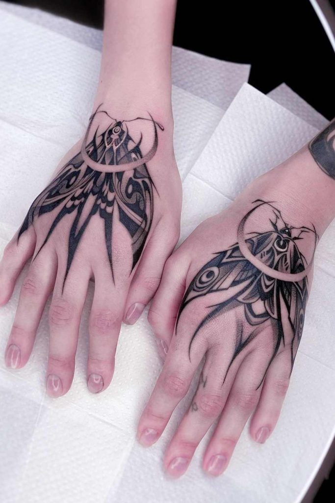 Matching Hand Moth Tattoos