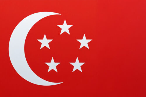 Which country’s flag has a white crescent and five stars on a red background?