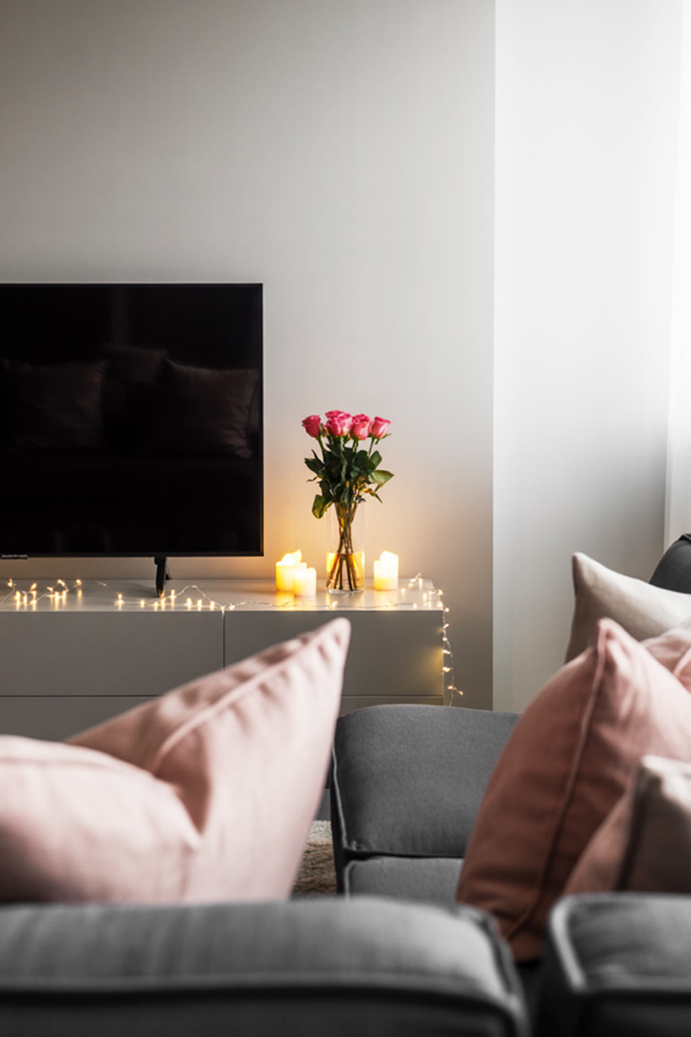 Cozy Living Room Decor With Roses, Candles, And Warm Fairy Lights
