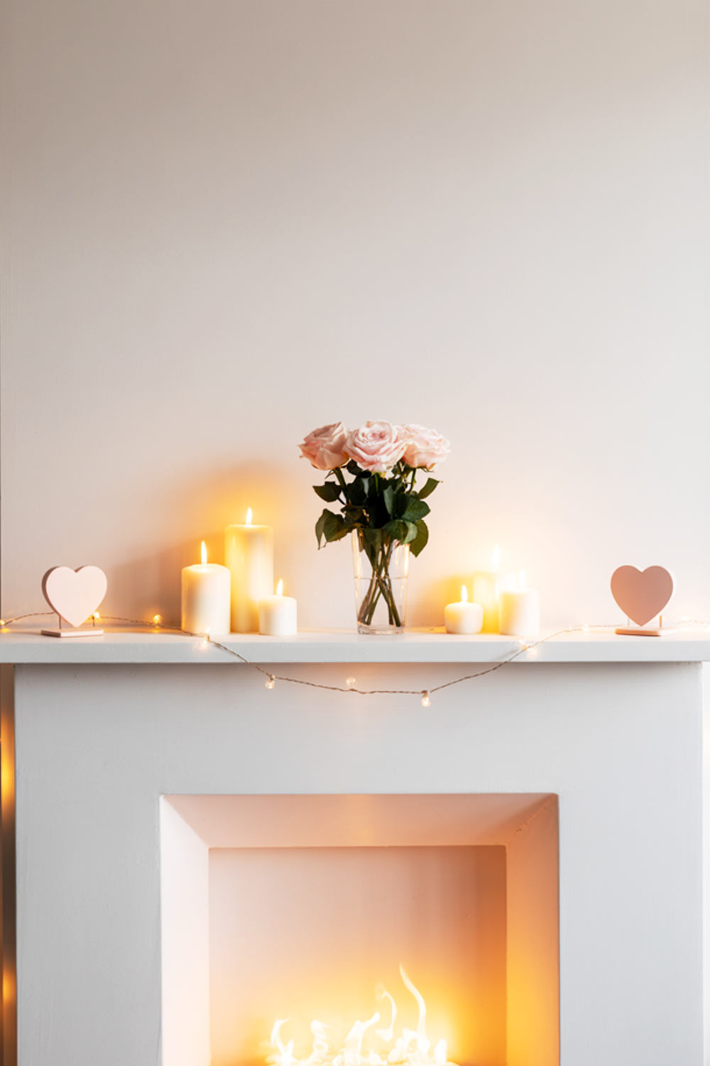 Minimalist Fireplace Decor With Candles, Flowers, And Heart Accents