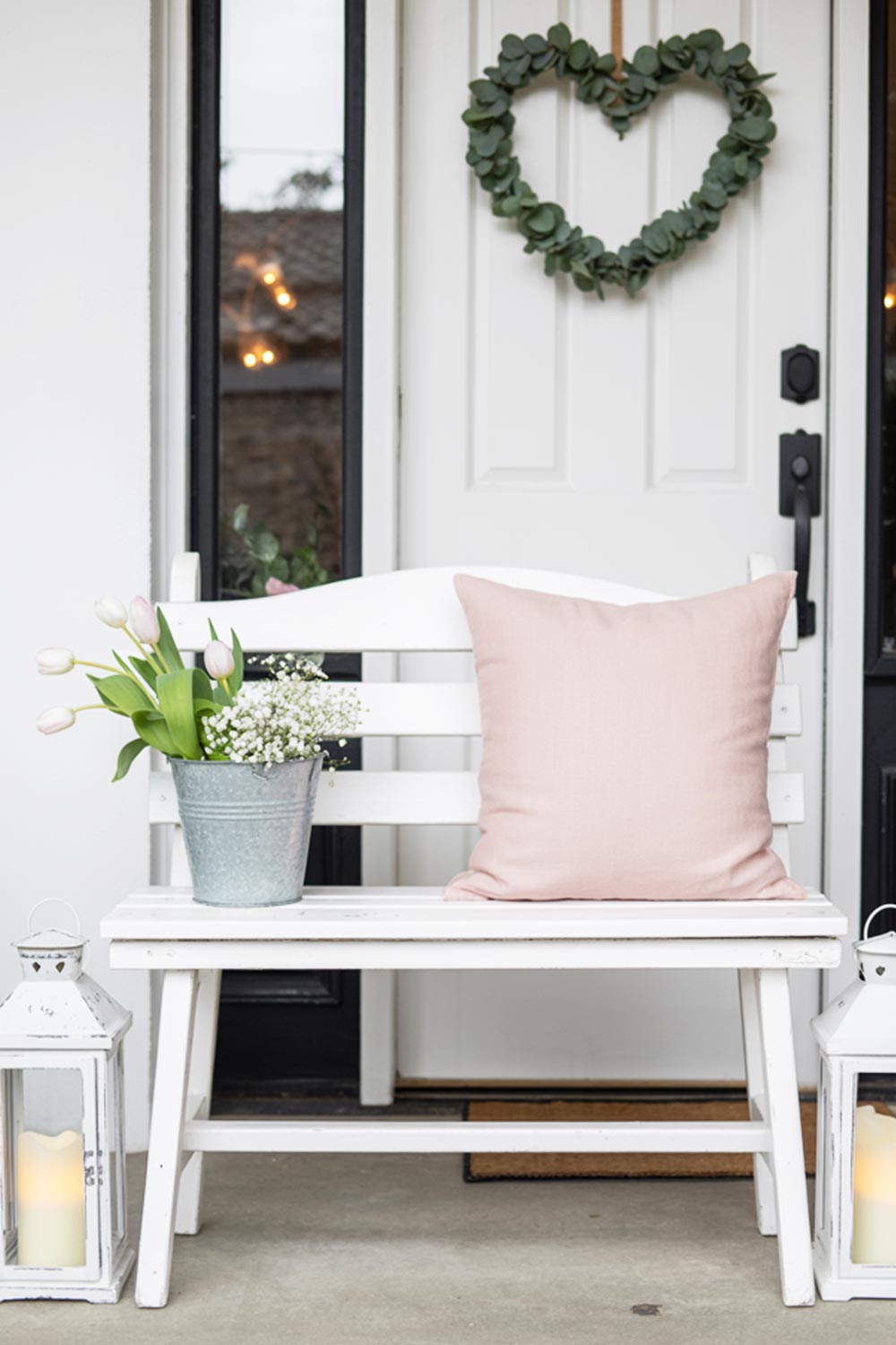 Front Porch Bench Decor With Flowers, A Heart Wreath, And Cozy Pillow