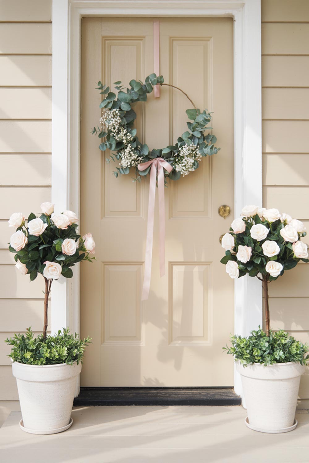 Front Porch Decor With A Floral Wreath And White Rose Arrangements