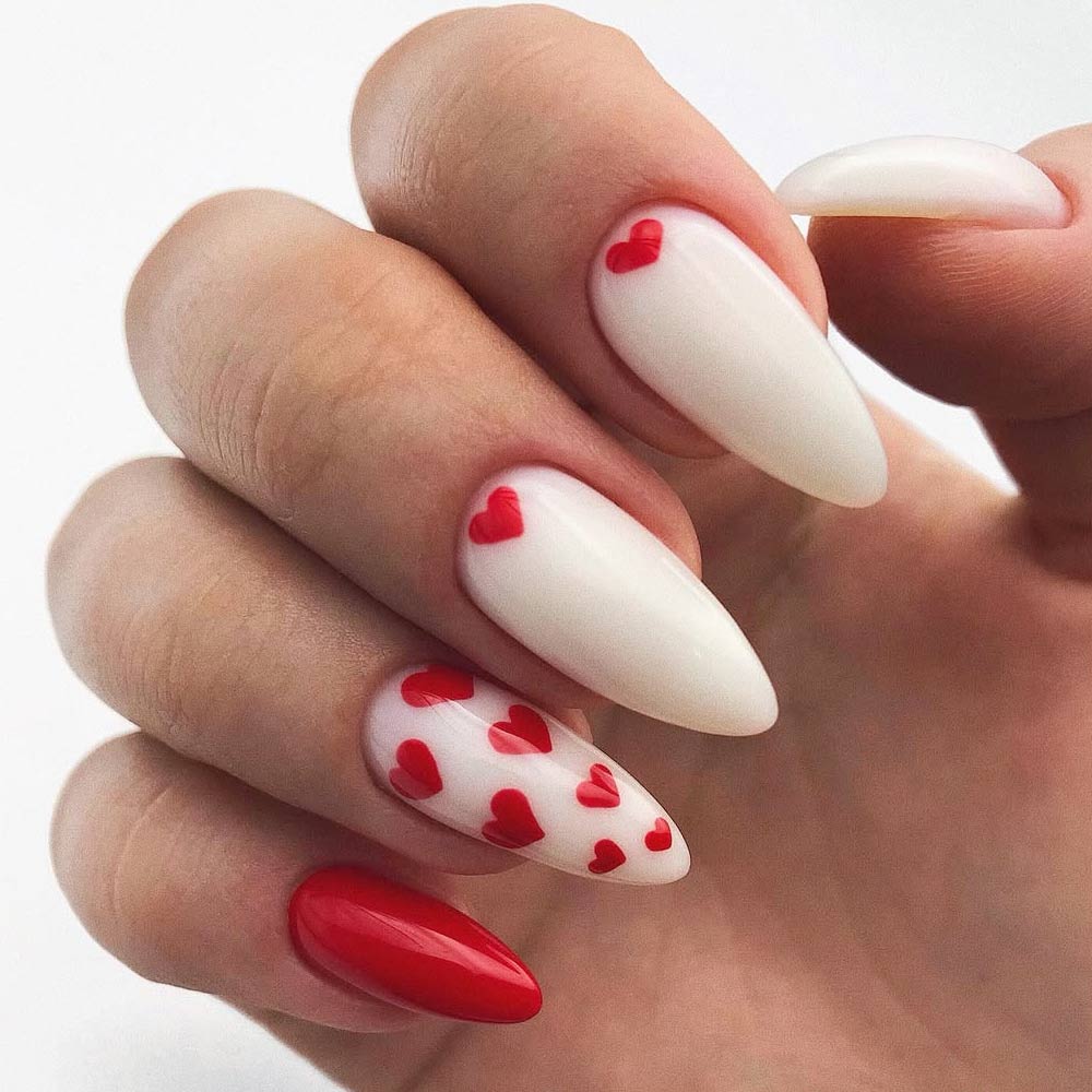 Sweet Heart-Print Nails with a Bold Red Accent