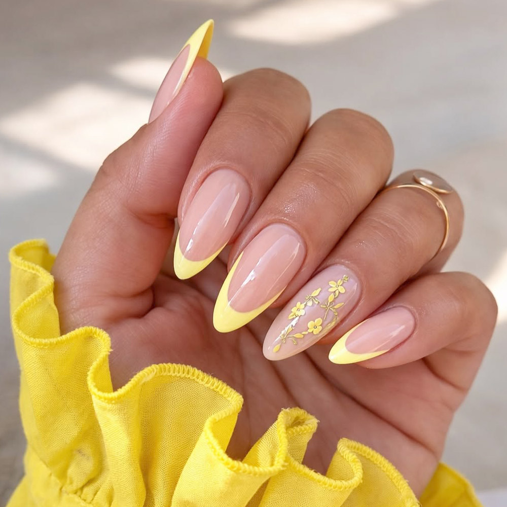 Yellow French Tip Almond Nails With Gold Floral Accent For Spring